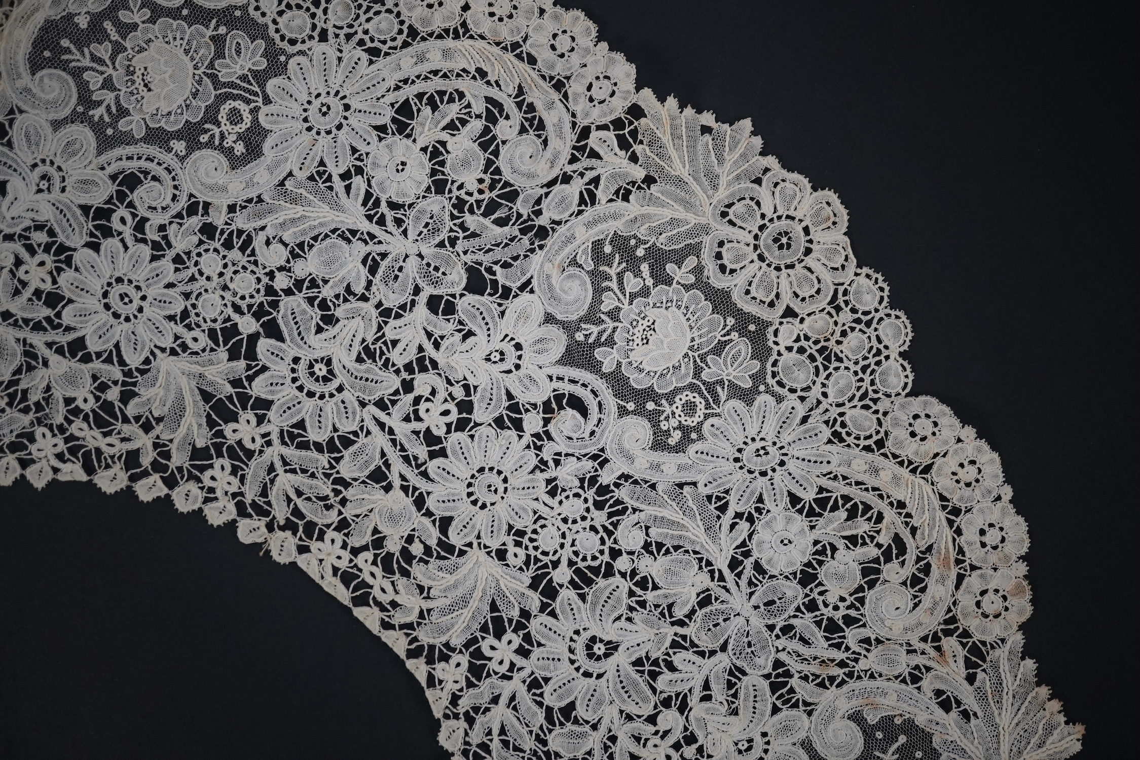 An 1860’s unused, large circular flounce shaped collar of mixed Brussels bobbin lace, with twelve needle lace Point de Gaz insertions, 18.5cm deep, approximately 248cm along bottom, edge. Condition - good